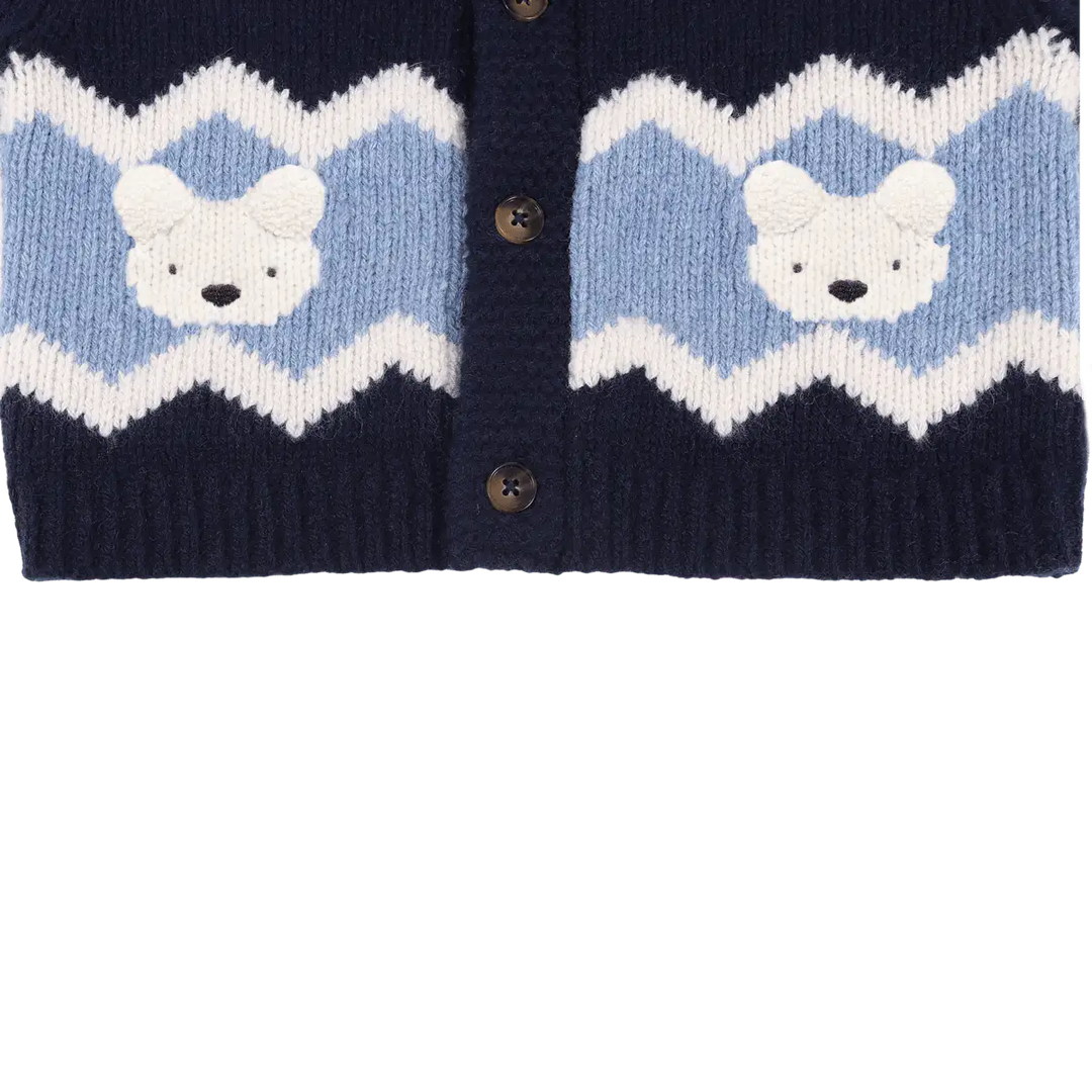 Donsje Kwinten Merino Wool Cardigan Polar Bears navy blue Detailansicht unterer Saum mit hellblauem und weißem Streifen und den eingestrickten Eisbären-Gesichtern. 