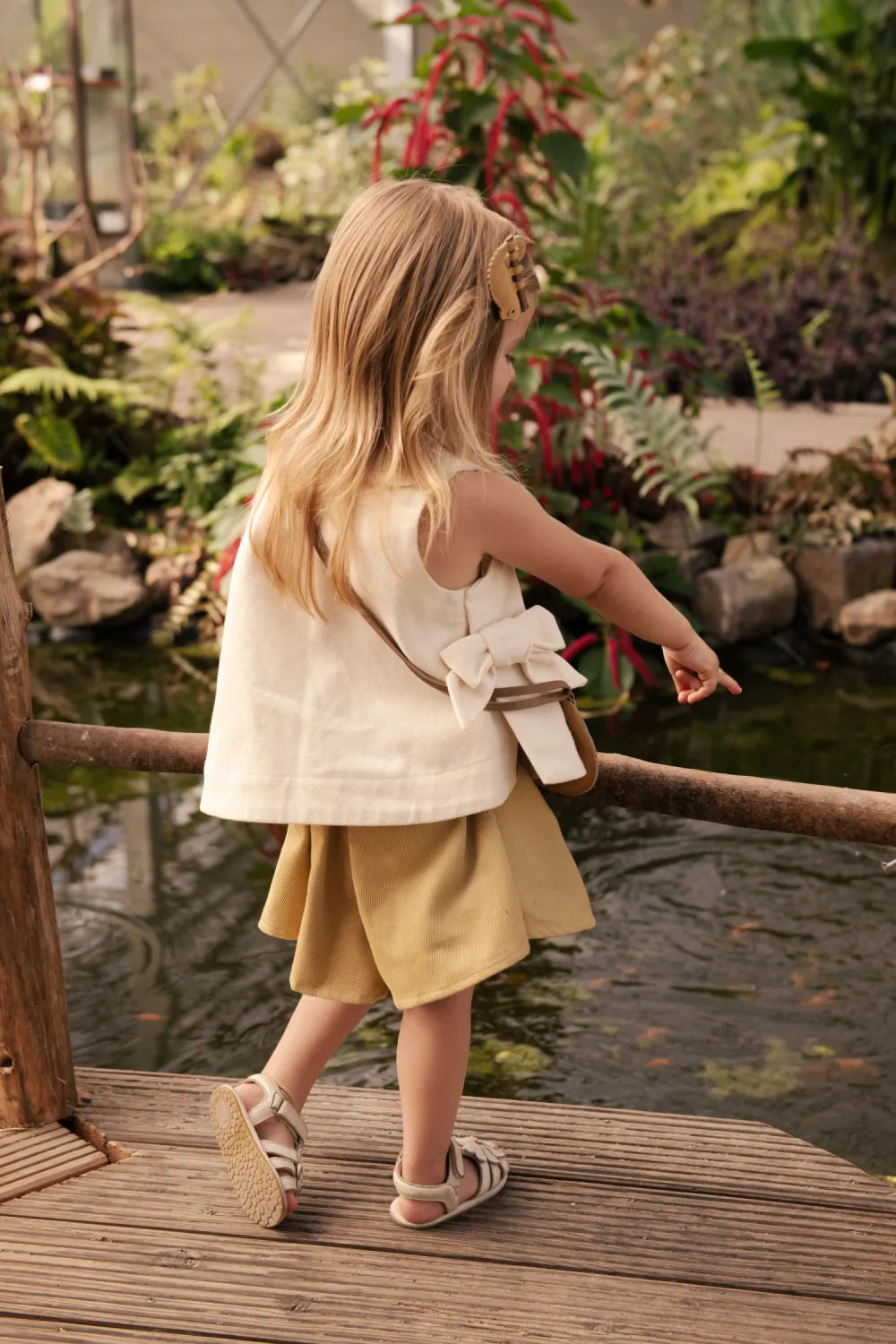 Donsje Veeri Top birch getragen von einem Mädchen, Ansicht von hinten mit Blick auf den boxy Schnitt und die seitliche Schleife