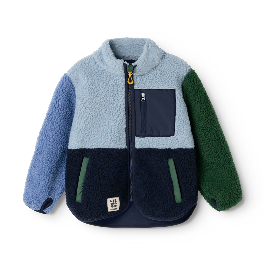 Fleecejacke für Kinder aus Teddyfell in verschiedenen Blau-Tönen mit einem grünen linken Ärmel und grünen Abnähern für die seitlichen Eingriffstaschen. Stehkragen und durchgehender Reißverschluss, Daumenlöcher an den Ärmel-Abschlüssen. Produktbild, Ansicht von vorne.