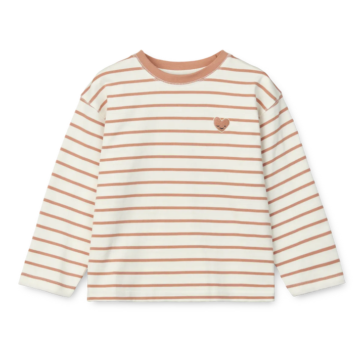 cremeweißes Langarmshirt für Mädchen aus Bio-Baumwolle mit dünnen altrosefarbenen Streifen und einem altrosefarbenem Rundhalsausschnitt und einem aufgestickten kleinen Herz mit Gesicht auf Höhe der linken Brust