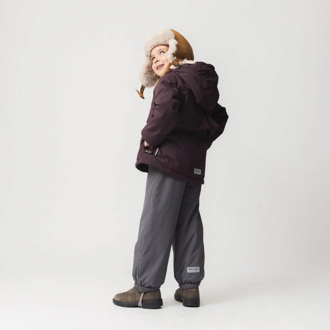 Mini A Ture Matalgeana fleece lined winter jacket GRS fudge aubergine getragen von einem Mädchen vor weißer Leinwand, Ansicht der Rückseite.
